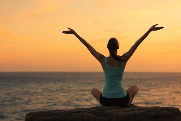 Woman celebrating in a peaceful setting.